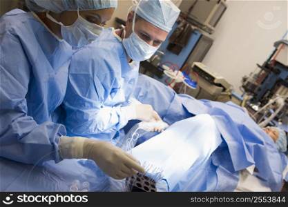 Woman in operating room undergoing egg retrieval procedure