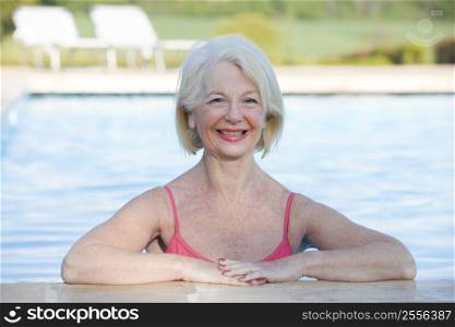 Woman in outdoor pool smiling