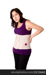 Woman in pain from back injury wearing an orthopedic body brace corset, isolated.