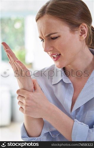 Woman In Pain Holding Wrist Suffering With Repetitive Strain Injury                         