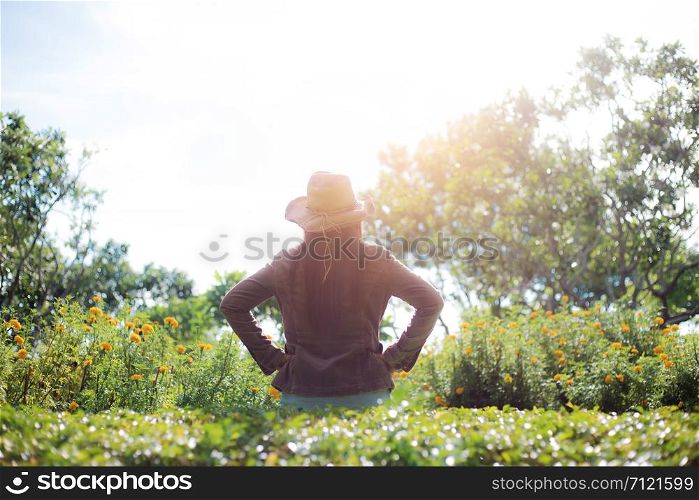 Woman in park with the sunlight at sky in summer.