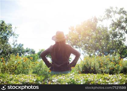 Woman in park with the sunlight at sky in summer.