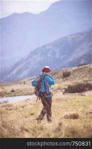 Woman in professional sportswear is hiking on the mountain, Austria