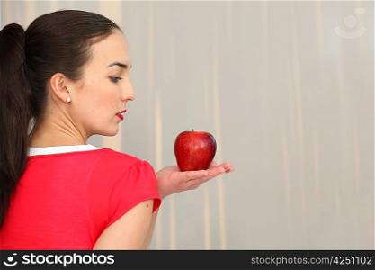 Woman in profile with red apple