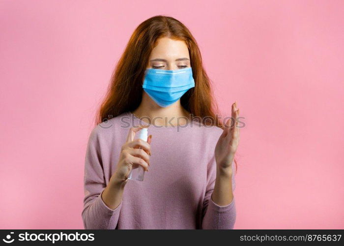 Woman in protective mask applies disinfectant antiseptic to her hands. Stop virus concept, bacteria protection. High quality photo. Woman in protective mask applies disinfectant antiseptic to her hands. Stop virus concept, bacteria protection.