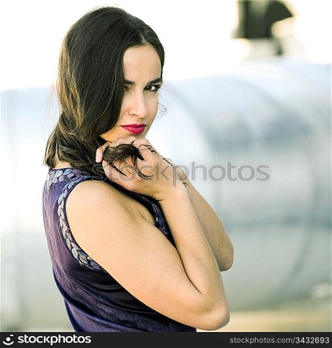 Woman in purple dress looking at the camera