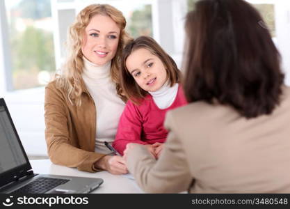 Woman in real-estate agency with kid