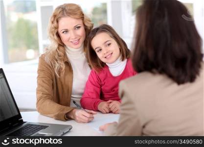 Woman in real-estate agency with kid