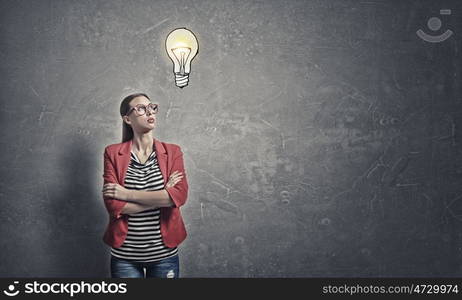 Woman in red jacket. Portrait of young woman in red jacket with arms crossed on chest looking away