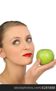Woman in red lipstick holding a green apple