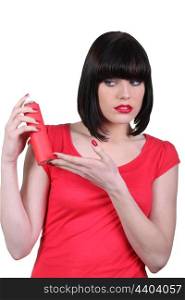 Woman in red looking warily at an aerosol