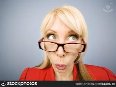 Woman in red pursing her lips and making a funny face