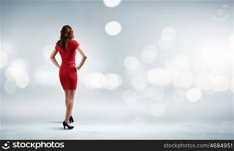 Woman in red. Rear view of woman in red dress against bokeh background