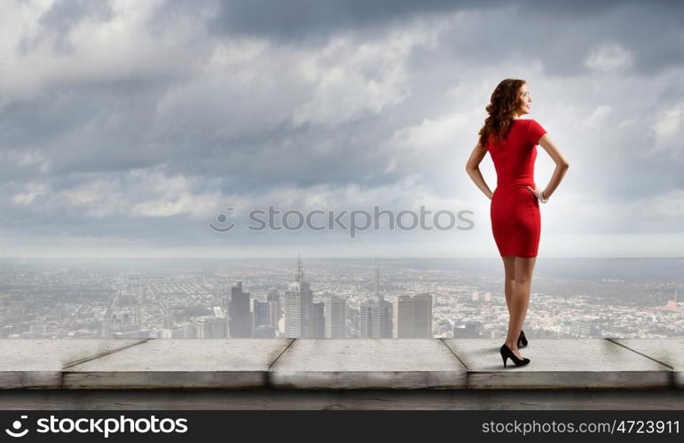 Woman in red. Rear view of young woman in red dress