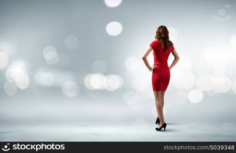 Woman in red. Rear view of young woman in red dress