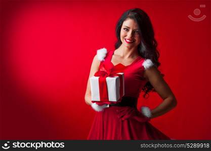 Woman in red Santa Claus outfit. Woman in red Santa Claus outfit holding christmas gift box