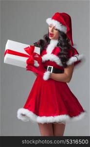 Woman in red Santa Claus outfit. Woman in red Santa Claus outfit holding christmas gift box