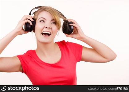 Woman in red shirt big headphones listening music mp3. Smiling female model on white. People leisure happiness concept.. Woman in big headphones listening music isolated