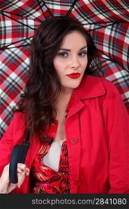 Woman in red with a tartan umbrella