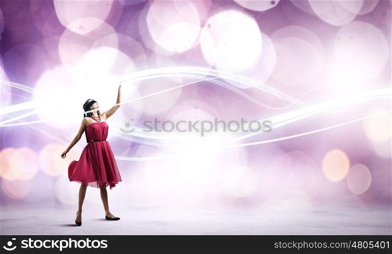 Woman in red. Woman in red dress and blindfold against bokeh background