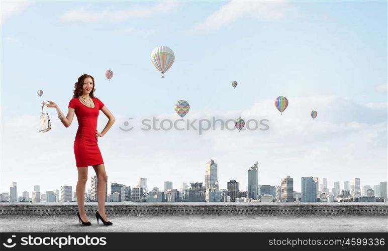 Woman in red. Woman in red dress with bag in hand