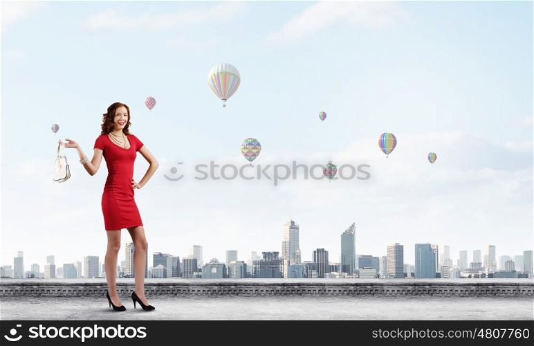 Woman in red. Woman in red dress with bag in hand