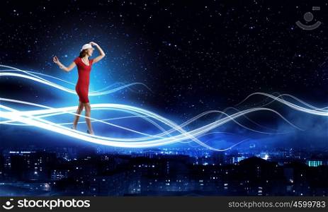 Woman in red. Young woman in red dress against night city background