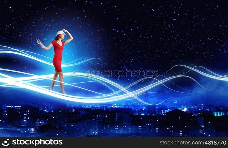 Woman in red. Young woman in red dress against night city background