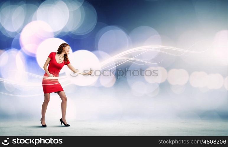 Woman in red. Young woman in red dress playing imaginary guitar