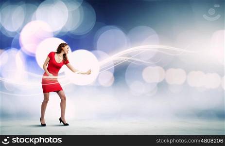 Woman in red. Young woman in red dress playing imaginary guitar