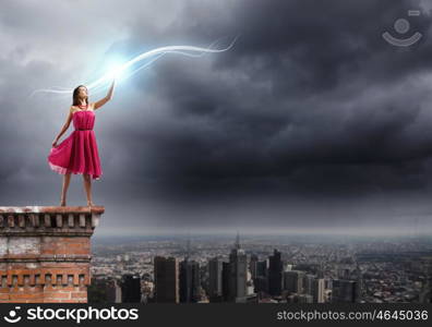 Woman in red. Young woman in red dress standing on top of building