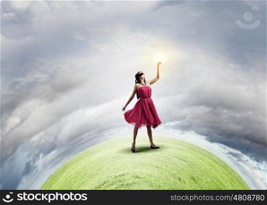 Woman in red. Young woman in red dress touching light spot