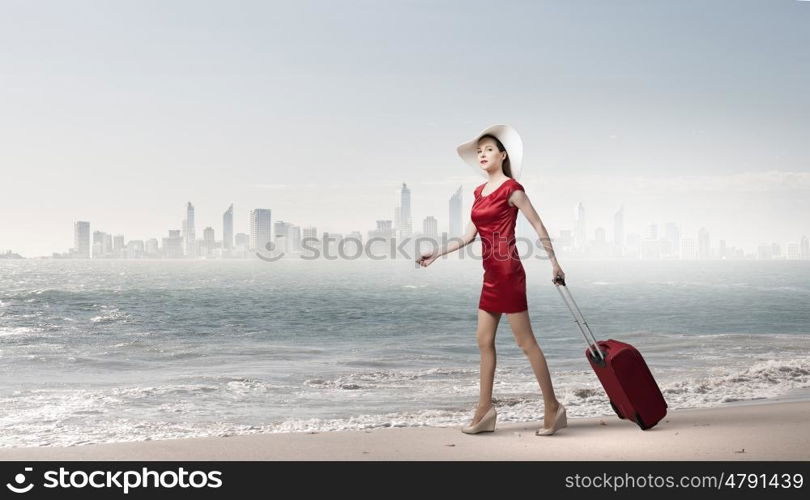 Woman in red. Young woman in red dress with red luggage