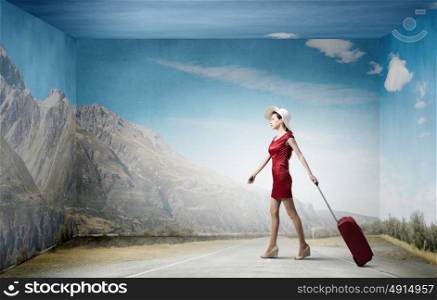 Woman in red. Young woman in red dress with red luggage