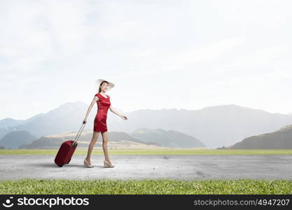 Woman in red. Young woman in red dress with red luggage