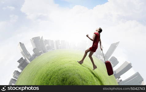 Woman in red. Young woman in red dress with red luggage