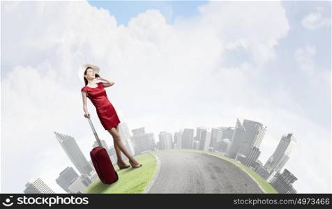Woman in red. Young woman in red dress with red luggage talking on mobile phone