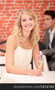 Woman in restaurant with a glass of champagne
