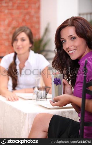 Woman in restaurant with birthday present