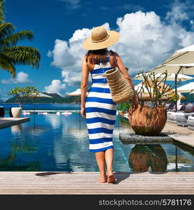 Woman in sailor striped dress near poolside jetty at Seychelles