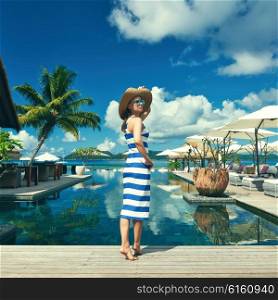 Woman in sailor striped dress near poolside jetty at Seychelles