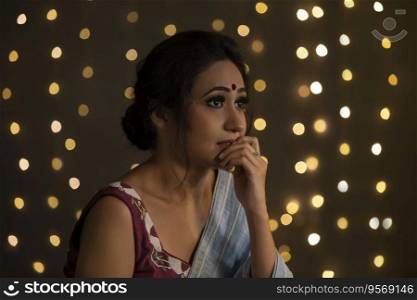 Woman in saree in a pensive mood. 