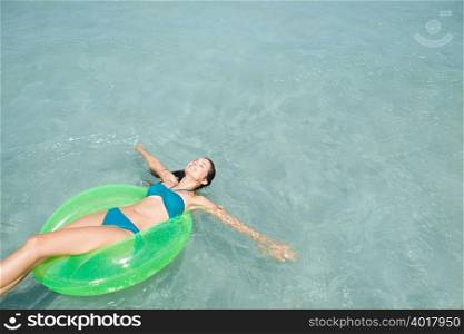 Woman in sea on inflatable ring