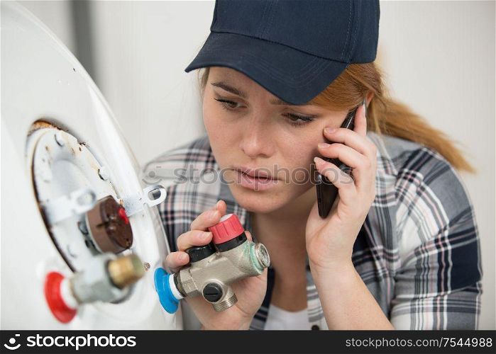 woman in shirt near boiler control panel