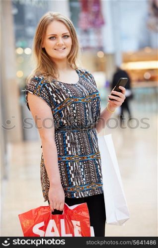 Woman In Shopping Mall Using Mobile Phone