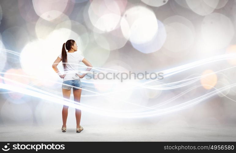 Woman in shorts. Rear view of young woman in shorts and white t-shirt