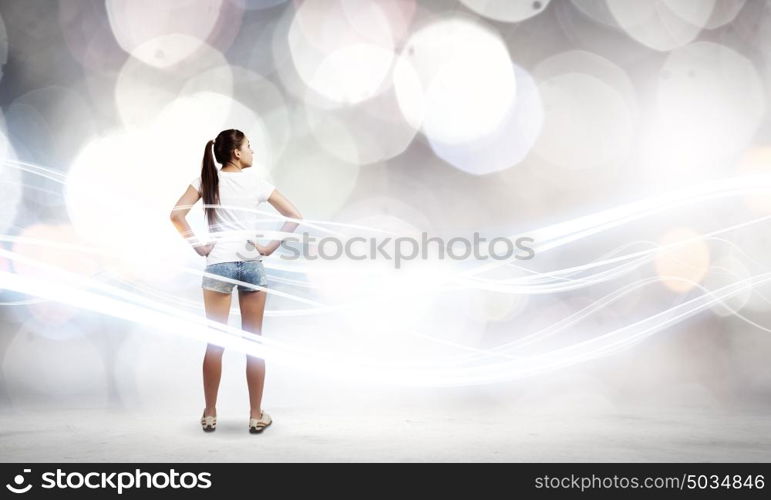 Woman in shorts. Rear view of young woman in shorts and white t-shirt