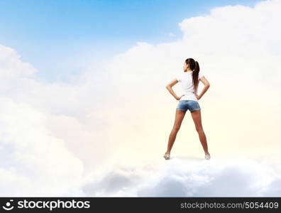 Woman in shorts. Rear view of young woman in shorts and white t-shirt