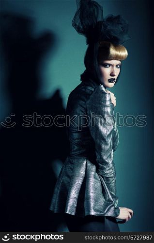 woman in silver jacket with black bow