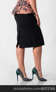 woman in skirt. side view of a woman wearing skirt and high heels